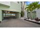 Exterior view of condo with covered parking area and inviting landscaping and beach views at 19530 Gulf Blvd # 4A, Indian Shores, FL 33785