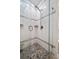 Beautiful glass shower stall featuring a pebble floor and white subway tile at 19530 Gulf Blvd # 4A, Indian Shores, FL 33785