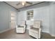 Cozy sitting area with comfortable chairs and a window with shutters at 19530 Gulf Blvd # 4A, Indian Shores, FL 33785