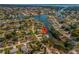 An aerial view of a waterfront community featuring lush greenery and canal access at 1980 Forked Creek Dr, Englewood, FL 34223