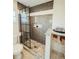 Modern bathroom featuring a glass-enclosed shower with stylish gray tiling and a granite countertop at 1980 Forked Creek Dr, Englewood, FL 34223
