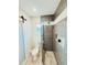 This bathroom has a stylish shower, and the room features a barn door for added character and privacy at 1980 Forked Creek Dr, Englewood, FL 34223