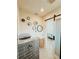 Bathroom featuring a gray tiled shower with a sleek black frame and a view into the main bedroom at 1980 Forked Creek Dr, Englewood, FL 34223