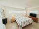 Cozy bedroom with a ceiling fan, two windows, and beachy decor at 1980 Forked Creek Dr, Englewood, FL 34223