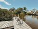 Private dock overlooking the tranquil waterway, with comfortable seating to enjoy the view at 1980 Forked Creek Dr, Englewood, FL 34223