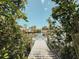 Wooden dock overlooking the serene waters, framed by lush green foliage at 1980 Forked Creek Dr, Englewood, FL 34223