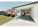 A well-maintained single-story house with a covered carport and an American flag at 1980 Forked Creek Dr, Englewood, FL 34223