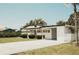 Charming single-story home with tidy front lawn, carport, and patriotic American flag at 1980 Forked Creek Dr, Englewood, FL 34223
