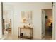 Hallway featuring a table with a lamp and artwork leading into rooms at 1980 Forked Creek Dr, Englewood, FL 34223