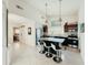 Modern kitchen with stainless steel appliances, a granite island, and a view of the bedroom at 1980 Forked Creek Dr, Englewood, FL 34223
