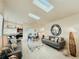 Open-concept living room features skylights, dining area, and updated kitchen at 1980 Forked Creek Dr, Englewood, FL 34223
