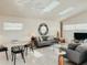 Bright and airy living room featuring modern furnishings, skylights, and unique flooring at 1980 Forked Creek Dr, Englewood, FL 34223