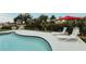 Inviting backyard pool with lounge chairs and tropical landscaping provides an idyllic outdoor living space at 1980 Forked Creek Dr, Englewood, FL 34223