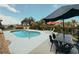 Backyard featuring a pool, outdoor furniture, and landscaping with a waterfront view at 1980 Forked Creek Dr, Englewood, FL 34223