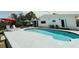Backyard pool with adjacent patio and comfortable lounge area, perfect for relaxing and entertaining at 1980 Forked Creek Dr, Englewood, FL 34223