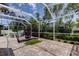 Screened-in patio with hot tub and golf net offers a relaxing and recreational outdoor space at 2220 Elizabeth Way, Dunedin, FL 34698
