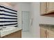 Bathroom with granite counter, tiled floor, and cabinet storage at 2220 Elizabeth Way, Dunedin, FL 34698