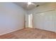 Bedroom features carpeted flooring, ceiling fan and closet for ample storage space at 2220 Elizabeth Way, Dunedin, FL 34698