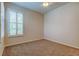 Bedroom featuring carpeted flooring, ceiling fan and plantation shutters that provide privacy and control natural light at 2220 Elizabeth Way, Dunedin, FL 34698