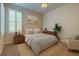 Bright bedroom with a ceiling fan, comfy bed, plantation shutters, and stylish decor, creating a relaxing space at 2220 Elizabeth Way, Dunedin, FL 34698