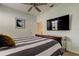 Bedroom featuring a mounted television, ceiling fan, and updated decor at 2220 Elizabeth Way, Dunedin, FL 34698