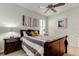 Bedroom with a queen-size sleigh bed, ceiling fan, and dual bedside tables at 2220 Elizabeth Way, Dunedin, FL 34698