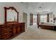 Bedroom featuring a four-poster bed, tray ceiling, and large dresser with mirror at 2220 Elizabeth Way, Dunedin, FL 34698