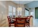 Elegant dining area featuring a round table, four chairs, and a decorative chandelier at 2220 Elizabeth Way, Dunedin, FL 34698