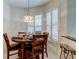 Inviting dining room with plantation shutters, chandelier, and seating for four at 2220 Elizabeth Way, Dunedin, FL 34698