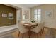 Bright dining room with a wood table, seating for six, and natural light from the large window at 2220 Elizabeth Way, Dunedin, FL 34698