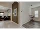 Inviting entryway featuring tile flooring, contrasted walls, adjacent living space, and a functional work area at 2220 Elizabeth Way, Dunedin, FL 34698