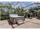 Hot tub with privacy screen and partial view of the surrounding neighborhood at 2220 Elizabeth Way, Dunedin, FL 34698