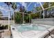 Relaxing hot tub area features a screened enclosure, offering a private and serene outdoor experience at 2220 Elizabeth Way, Dunedin, FL 34698