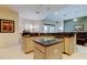 Open-concept kitchen with an island, granite countertops, and stainless steel appliances at 2220 Elizabeth Way, Dunedin, FL 34698