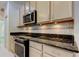 Bright eat-in kitchen with stainless steel oven and range and granite countertop at 2220 Elizabeth Way, Dunedin, FL 34698