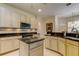 Modern kitchen featuring an island, granite counters, and stainless steel appliances at 2220 Elizabeth Way, Dunedin, FL 34698
