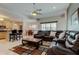 Inviting living room with leather seating, a ceiling fan, and views into the kitchen at 2220 Elizabeth Way, Dunedin, FL 34698
