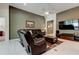 Comfortable living room with leather furniture, a ceiling fan, and neutral tones at 2220 Elizabeth Way, Dunedin, FL 34698