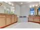 Bright bathroom features dual vanities, a soaking tub, and elegant lighting at 2220 Elizabeth Way, Dunedin, FL 34698