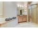 Bright bathroom features dual vanities, a soaking tub, and glass shower enclosure at 2220 Elizabeth Way, Dunedin, FL 34698