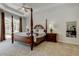 Spacious main bedroom featuring a tray ceiling, and access to the outdoor patio at 2220 Elizabeth Way, Dunedin, FL 34698