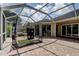 Outdoor patio with brick flooring features a golf simulator area, perfect for golf enthusiasts at 2220 Elizabeth Way, Dunedin, FL 34698