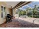 Relaxing outdoor patio with brick flooring, complete with grill and spa area for entertaining at 2220 Elizabeth Way, Dunedin, FL 34698
