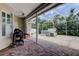 Relaxing outdoor patio with brick flooring, complete with grill and spa area for entertaining at 2220 Elizabeth Way, Dunedin, FL 34698