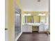 Dual sink bathroom with stylish tiled shower and modern fixtures at 27012 Sea Breeze Way, Wesley Chapel, FL 33544