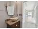 Stylish bathroom with a vessel sink and view to a bright, open floor plan at 27012 Sea Breeze Way, Wesley Chapel, FL 33544