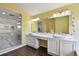 Bright bathroom showcases double sinks, a large mirror, and a glass-enclosed shower at 27012 Sea Breeze Way, Wesley Chapel, FL 33544