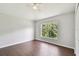 Bright bedroom with light-colored walls, a ceiling fan, and wood-look floors at 27012 Sea Breeze Way, Wesley Chapel, FL 33544