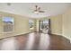 Bright bedroom with wood floors, ceiling fan, and natural light from large windows at 27012 Sea Breeze Way, Wesley Chapel, FL 33544