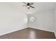 Light bedroom with hardwood floors, modern ceiling fan, and stylish round window at 27012 Sea Breeze Way, Wesley Chapel, FL 33544